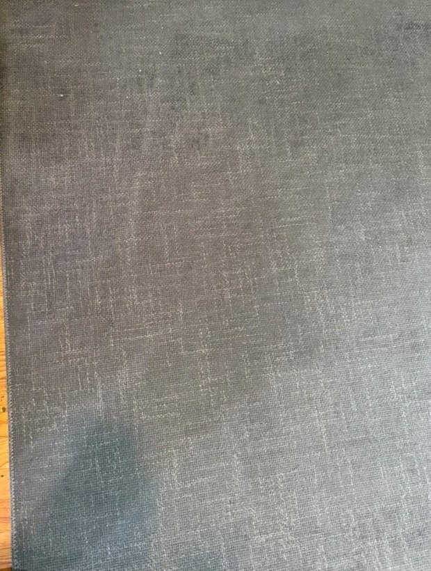 The same rug corner after steam extraction, evenly clean and stain-free